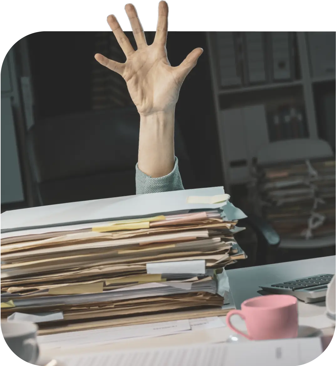 Someone raising their hand from behind stacks of resumes